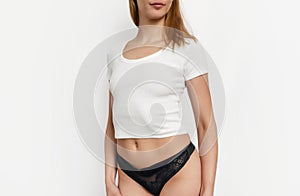 Slim attractive woman in white t-shirt and black underpants. Sexuality, attractiveness