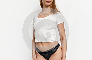 Slim attractive woman in white t-shirt and black underpants. Sexuality, attractiveness photo