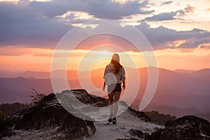 Slim beautiful girl walks mountains at sunset