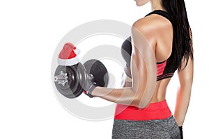 Slim, bodybuilder girl, lifts heavy dumbbell while training in the gym.