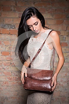 Slim brunette with handbag