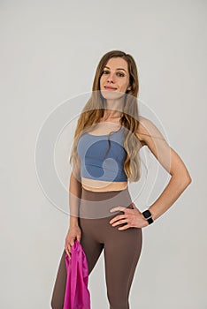 Slim caucasian woman during workout training muscles using rubber bands  on white