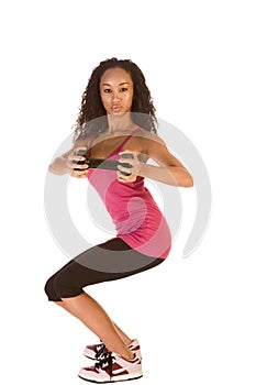 Slim ethnic woman working out with black dumbbell