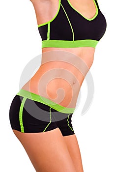 Slim figure of girl is in a sportwear photo