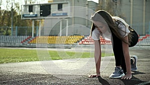 Slim fit asian runner in sportswear prepares to run. sprinting on stadium track