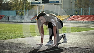 Slim fit asian runner in sportswear prepares to run. sprinting on stadium track