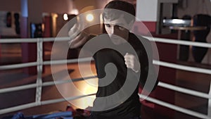 Slim fit, attractive guy boxer is engaged in the ring, preparing for the first fight, concentrating on the strokes. Slow