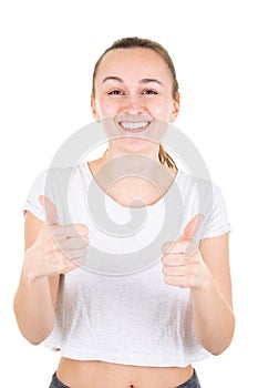 Slim fit happy smiling young fitness woman showing thumbs up over white background