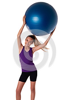 Slim and fit teen girl holding a swiss blue ball with arms up. Shot on white background