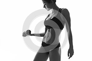 slim fit woman body with dumbbells. Muscled abdomen. Sports