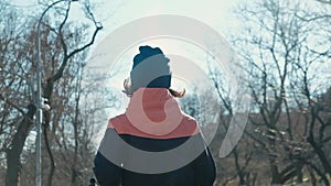 Slim fit young woman running or jogging over camera outdoors. Low angle view