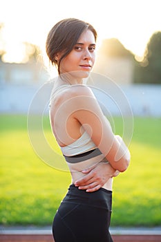 Slim fitness woman posing at the run track