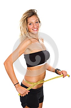 Slim girl measuring her waist