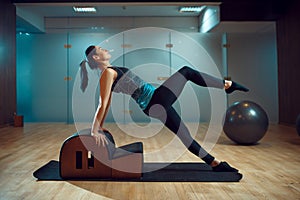 Slim girl on pilates training in gym, flexibility
