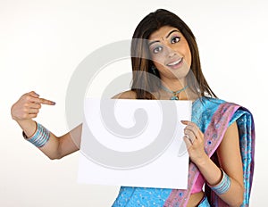 slim girl in sari holding white placard