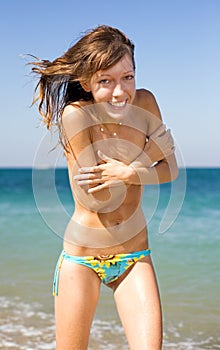 Slim girl on seashore