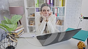 Slim gorgeous young woman sitting in office dreaming about vacations. Portrait of beautiful Caucasian female employee