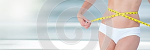 Slim healthy woman holding measuring tape