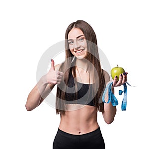 Slim and healthy young woman holding measure tape and apple isolated on white background. Weight loss and diet concept.