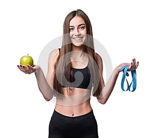 Slim and healthy young woman holding measure tape and apple isolated on white background. Weight loss and diet concept.