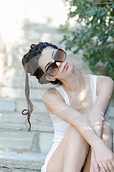slim lady wear tight short white dress and sunglasses