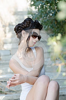 slim lady wear tight short white dress and sunglasses