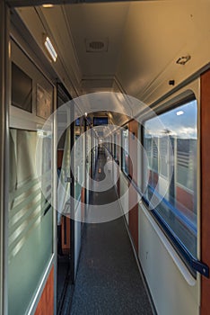 Slim light corridor in expres train in Czech republic