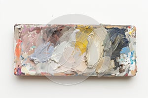 slim, rectangular palette filled compactly with muted oil paint tones