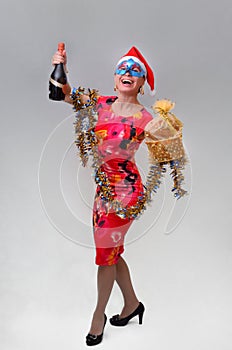 Slim smiling girl with gift and champagne