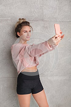 Slim sportive blonde taking selfie