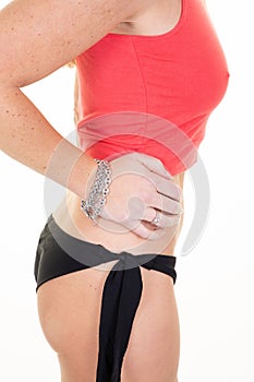 Slim tanned woman body and bracelet jewellery in hand Isolated over white background