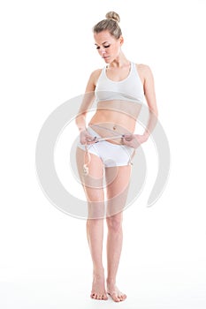 Slim tanned woman`s body over white background