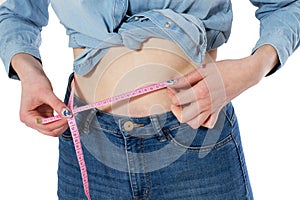 Slim waist with a tape measure around it, fitness body, Woman measuring perfect shape of beautiful hips. Healthy lifestyles