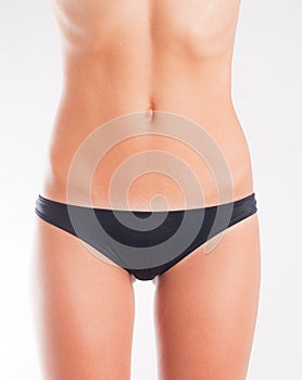 Slim woman in black knickers photo