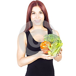 Slim woman with a bowl of fresh vegetables. Diet and proper nutrition.