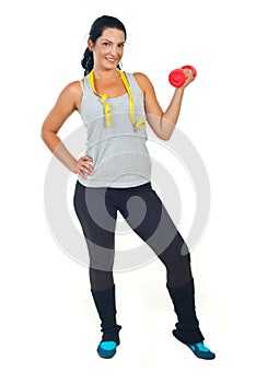 Slim woman with centimeter holding barbell