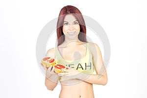 Slim woman holding grapefruit in arms. Diet and proper nutrition.