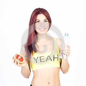 Slim woman holding grapefruit and bottle of water. Diet and proper nutrition.