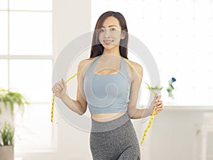 Slim woman and measure tape around her body.Fitness
