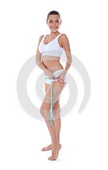 Slim woman measuring her hips on white background.