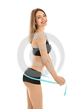 Slim woman measuring her hips on white background
