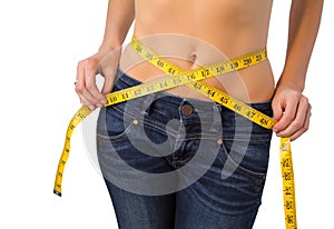 Slim woman measuring her waist