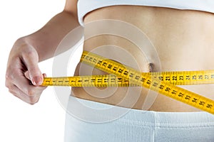 Slim woman measuring her waist