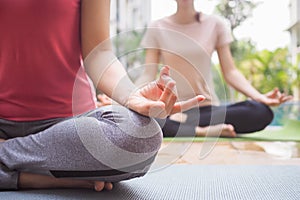 Slim woman practicing yoga near swimming pool at condo. Asian woman doing exercises in morning. balance, meditation, relaxation,