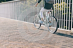 Slim woman rides a city bike