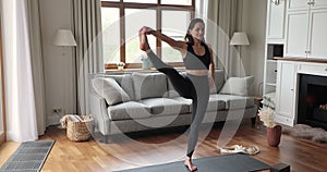 Slim yogini woman wear black sportswear perform yoga asanas indoor