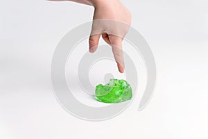 Slime in the hand of a child on a light background. The child plays with mucus and develops fine motor skills of the hands