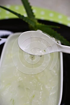 Aloe vera slime sliding off the spoon photo