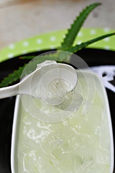 Spoon with Aloe vera slime in bowl photo