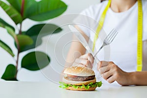 Slimming concept, young woman with sealed mouth giving up junk food